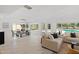 Open concept living room with dining room and views of backyard pool at 1509 W Kiowa Ave, Mesa, AZ 85202