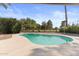 Outdoor pool with a well-manicured yard and mature trees in the background at 1509 W Kiowa Ave, Mesa, AZ 85202