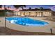 A backyard featuring a sparkling pool with lights strung on the house above at 1509 W Kiowa Ave, Mesa, AZ 85202