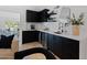 Elegant wet bar with sleek black cabinetry, wine fridge, and modern finishes at 1509 W Kiowa Ave, Mesa, AZ 85202