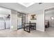 Open dining area leading to a laundry room and bedroom, featuring modern furnishings at 15610 N 29Th St # 3, Phoenix, AZ 85032
