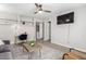 Comfortable living room featuring a large television, built-in shelving and neutral decor at 15610 N 29Th St # 3, Phoenix, AZ 85032