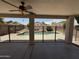 A covered patio overlooking a fenced-in backyard with a refreshing in-ground pool at 16784 W Polk St, Goodyear, AZ 85338