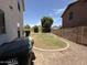 Large backyard offers ample space and a mature shade tree at 16784 W Polk St, Goodyear, AZ 85338