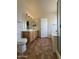 Bright bathroom featuring a double sink vanity, tile floors, and a separate shower at 16784 W Polk St, Goodyear, AZ 85338
