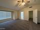 Open bedroom space features neutral walls, plush carpeting and natural lighting at 16784 W Polk St, Goodyear, AZ 85338