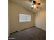 Carpeted bedroom with vaulted ceiling and ceiling fan at 16784 W Polk St, Goodyear, AZ 85338