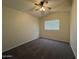 Bedroom featuring carpet, ceiling fan and a window at 16784 W Polk St, Goodyear, AZ 85338