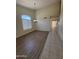 Inviting dining area featuring hardwood floors, chandelier, large window, and staircase at 16784 W Polk St, Goodyear, AZ 85338