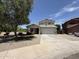 Well-maintained two story home featuring a front yard with xeriscaping at 16784 W Polk St, Goodyear, AZ 85338