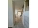 Hallway featuring tile floor leading into an open concept home with staircase at 16784 W Polk St, Goodyear, AZ 85338