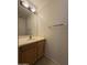 Powder room featuring wood vanity, mirror and lighting at 16784 W Polk St, Goodyear, AZ 85338