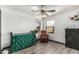 Bedroom featuring an iron crib, wood-look floors, and neutral paint at 1700 S Martingale Rd, Gilbert, AZ 85295