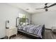 Cozy bedroom with a ceiling fan, window for natural light, and wood-look flooring at 1700 S Martingale Rd, Gilbert, AZ 85295