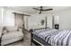 Serene bedroom with ceiling fan, sliding barn door, and a comfortable lounge chair at 1700 S Martingale Rd, Gilbert, AZ 85295