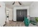 Bedroom featuring an iron crib, wood-look floors, and neutral paint at 1700 S Martingale Rd, Gilbert, AZ 85295