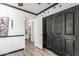 Hallway featuring dark-paneled doors, neutral paint, and wood-look floors at 1700 S Martingale Rd, Gilbert, AZ 85295