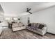 Spacious living room with wood-look floors, filled with comfortable seating and natural light at 1700 S Martingale Rd, Gilbert, AZ 85295