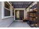 A concrete patio with dark wooden awning, sliding glass doors and workout equipment at 1700 S Martingale Rd, Gilbert, AZ 85295