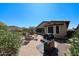 Backyard featuring a grill, fire pit, and desert views at 17516 W Glenhaven Dr, Goodyear, AZ 85338