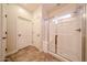 Bathroom featuring a glass shower with tan tiled flooring and white trim at 17516 W Glenhaven Dr, Goodyear, AZ 85338