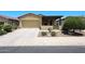 Attractive single-story home featuring a desert landscape, covered porch, and a two car garage at 17516 W Glenhaven Dr, Goodyear, AZ 85338