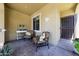 Welcoming covered front porch with tiled floors, comfortable seating, and decorative accents at 17516 W Glenhaven Dr, Goodyear, AZ 85338