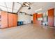 Spacious garage with ample cabinet storage and epoxy floors is perfect for organization at 17516 W Glenhaven Dr, Goodyear, AZ 85338