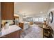Spacious open concept kitchen with stainless steel appliances and views of the cozy living area at 17516 W Glenhaven Dr, Goodyear, AZ 85338