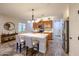 Open kitchen with an island, stainless appliances, wood cabinets, tile backsplash and countertops and tile flooring at 17516 W Glenhaven Dr, Goodyear, AZ 85338