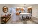 Open kitchen with an island, stainless appliances, wood cabinets, tile backsplash and countertops and tile flooring at 17516 W Glenhaven Dr, Goodyear, AZ 85338