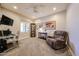 Cozy room featuring soft carpeting, a ceiling fan, and a comfortable recliner chair at 17516 W Glenhaven Dr, Goodyear, AZ 85338
