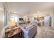 Open-concept living space featuring neutral decor, ample seating, and natural light at 17516 W Glenhaven Dr, Goodyear, AZ 85338
