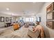 Spacious living room and dining area, featuring a large rug, ceiling fan, and neutral decor at 17516 W Glenhaven Dr, Goodyear, AZ 85338