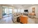 Bright living room featuring comfortable seating, a fireplace, and sliding glass doors to the patio at 17516 W Glenhaven Dr, Goodyear, AZ 85338