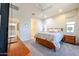 Spacious bedroom with ensuite bathroom, ceiling fan, carpet, and a view of the bathroom at 17516 W Glenhaven Dr, Goodyear, AZ 85338