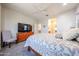 Comfortable main bedroom featuring a ceiling fan and an ensuite bathroom entrance at 17516 W Glenhaven Dr, Goodyear, AZ 85338