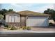 Charming single-story home featuring stone accents, a two-car garage, and a welcoming front yard at 17586 W Monroe St, Goodyear, AZ 85338