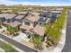 Expansive aerial view of the neighborhood showcasing the property with solar panels and lush desert landscaping at 17721 W Cassia Way, Goodyear, AZ 85338