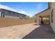 Expansive backyard with a brick wall, offering ample space for outdoor activities and privacy at 17721 W Cassia Way, Goodyear, AZ 85338