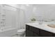 Well-lit bathroom featuring a tub and shower combination, toilet, and a vanity with dark wood cabinets at 17721 W Cassia Way, Goodyear, AZ 85338