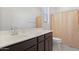 Bathroom featuring a light-colored vanity with dark cabinets and a coordinated shower curtain with polka dots at 17721 W Cassia Way, Goodyear, AZ 85338