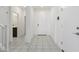Bright entryway featuring tile flooring, a white front door, and clear sightlines to an adjacent half bath at 17721 W Cassia Way, Goodyear, AZ 85338