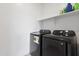 Functional laundry area equipped with a modern washer and dryer set, and a shelf for storage at 17721 W Cassia Way, Goodyear, AZ 85338