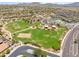 Aerial view of the neighborhood park, featuring green spaces, sports courts, and picnic areas at 17721 W Cassia Way, Goodyear, AZ 85338