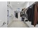 Spacious walk-in closet with shelving and hanging racks on both sides, offering ample storage space at 17721 W Cassia Way, Goodyear, AZ 85338