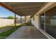 Covered patio and fenced backyard area with grass and desert landscaping at 1845 N 64Th St, Scottsdale, AZ 85257
