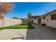 Expansive backyard features grass, covered patio, and mature trees offering shade and privacy at 1845 N 64Th St, Scottsdale, AZ 85257