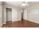 Bedroom with wood floors, ceiling fan, and closet with sliding doors at 1845 N 64Th St, Scottsdale, AZ 85257