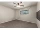 Bedroom features carpet, a window, and ceiling fan at 1845 N 64Th St, Scottsdale, AZ 85257